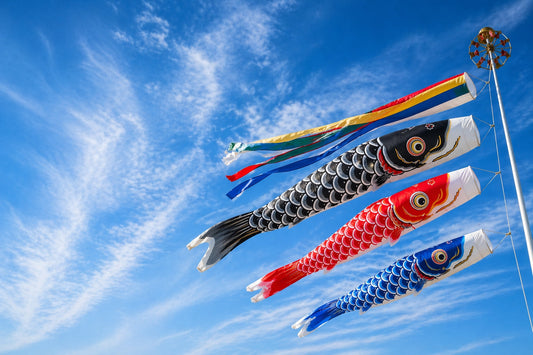 Koinobori carp streamers swimming against the wind in a bright blue sky in Japan